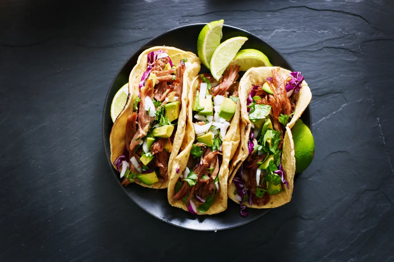 New Project(3) Three tacos with lime on plate.